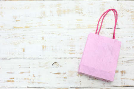 pink Shopping bag on a wooden backgroundの写真素材