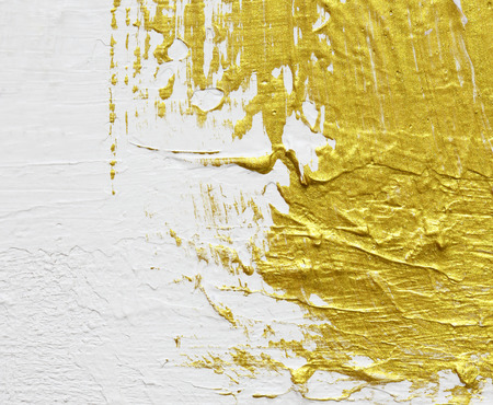 gold textured abstract painting on white backgroundの写真素材