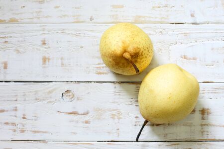 Fresh oriental pear on a white wood backgroundの写真素材