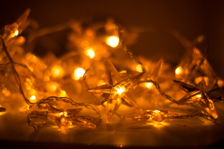 Christmas bright led lights stars with bokeh effect as luminous background.の写真素材