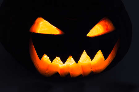 Scary Halloween Pumpkin Head glowing al night. Dark Background. Jack-o-lantern.の写真素材