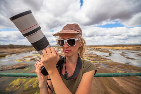Photographer woman selfie on a Olifants river bridge, Kruger National Park, Limpopo, South Africa.の写真素材