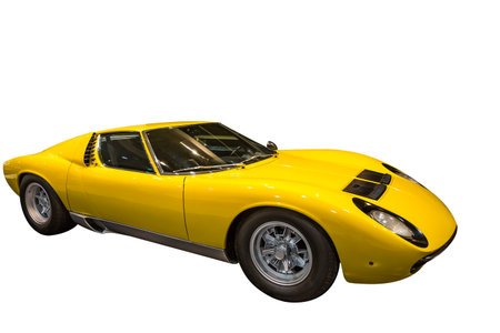 Side view of a luxurious yellow Lamborghini sports car on a white background.