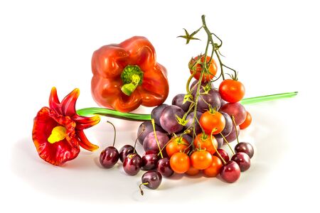 Group of assorted bright red fruit and vegetables with glass flower. Isolated on white .の写真素材