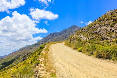Gravel mountain road in Mountain Zebra National Park in summer, Eastern Cape province of South Africa.の写真素材