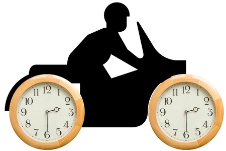 Motorcyclist in silhouette on a motorbike whose wheels are clocks set to 2 30 pm, white background.  .の写真素材