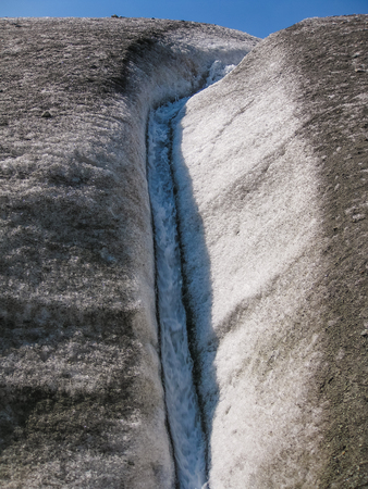 Closeup of the river running through the Kennicott Glacier during the trek that leads to the glacier. Summer, Wrangell St. Elias National Park in Alaska, USA.の写真素材