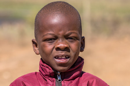 Portrait of a poor and worried South African child on the road leading to UMkhuze Game Reserve, South Africa.のeditorial素材