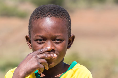 Portrait of a poor and thoughtful South African child on the road leading to UMkhuze Game Reserve, South Africa.のeditorial素材