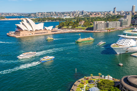Sydney, Australia - December 29, 2014: center skyline scenery with Opera House, Royal Botanic Gardens, Circular Quay, harbor with huge transoceanic ship, Sydney Towerのeditorial素材