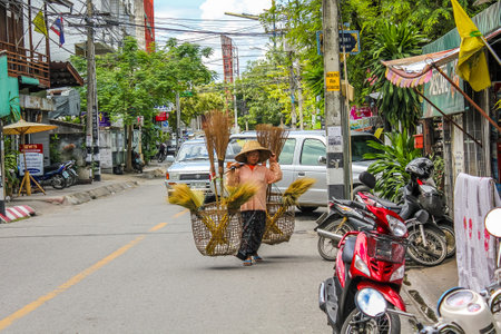 Chiang Mai, Thailand - July 24, 2011: Thai woman carries the big basketsのeditorial素材