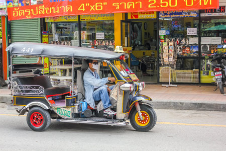 Chiang Mai, Thailand - July 23, 2011: Tuk tuk, local taxi, on the street in  town.のeditorial素材