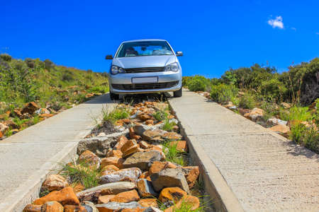 Car in stone dangerous road in the blue sky, Mountain Zebra National Park in summer, Eastern Cape province of South Africa.の写真素材
