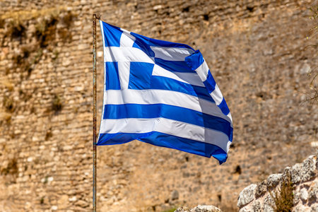 Flag of Greece waving on mountain background.