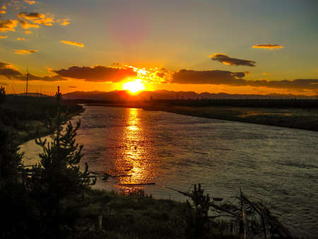Beautiful sunset reflected in Yellowstone River in Yellowstone National Park, Wyoming, United States.の写真素材