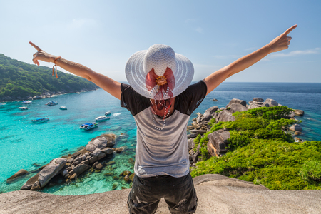 Happy tourist enjoys panorama from Sail Rock View Point of kor 8 of Similan Islands National Park, Phang Nga, Thailand, one of the tourist attraction of the Andaman Sea.の写真素材