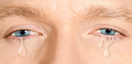 Crying blue eyes of caucasian white man. concept of sadness,fear, love pains, mental depression...