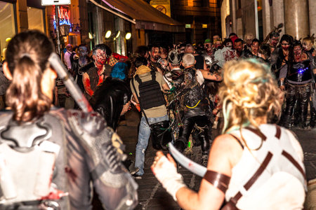 Bologna, Italy - May 21, 2016: Bologna zombie apocalypse walk, a group of people dressed as zombies and scary expressions during a parade through the center of the city.のeditorial素材