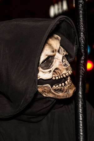 Portrait of the face of death with a scythe for Halloween by night.の写真素材