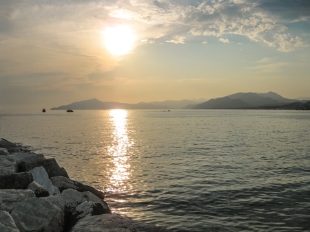 Sunset over the sea in the famous beach of the Bay of Fairy Tales in Sestri Levante, Province of Genoa in Liguria, Italy.の写真素材