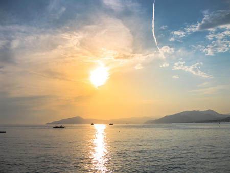 Sunset over the sea in the famous beach of the Bay of Fairy Tales in Sestri Levante, Province of Genoa in Liguria, Italy.の写真素材