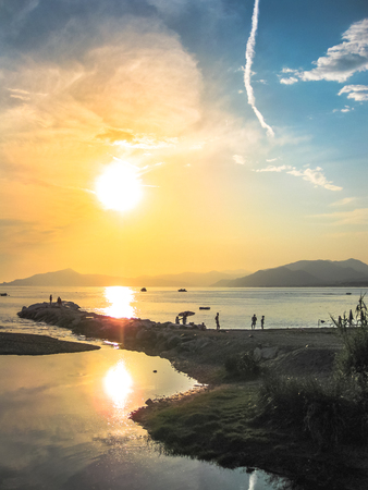 Sunset over the sea in the famous beach of the Bay of Fairy Tales in Sestri Levante, Province of Genoa in Liguria, Italy.の写真素材