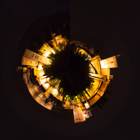Little planet composition aerial view on top of a fortified city with fortress and towers, in a night skyの写真素材