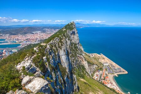 Aerial view of top of Gibraltar Rock, in Upper Rock Natural Reserve: on the left Gibraltar town and bay, La Linea town in Spain at the far end, Mediterranean Sea on the right. United Kingdom, Europe.の写真素材
