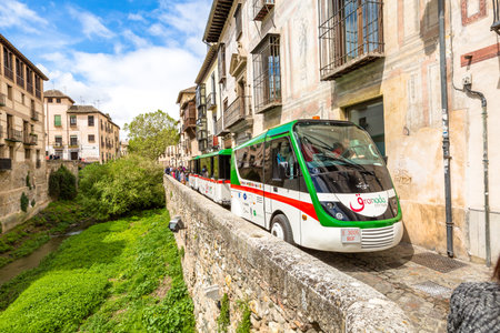 Granada, Andalucia, Spain - April 16, 2016: Granada City Tour with the shuttle along the Carrera del Darro in the popular old Moorish Albaicin quarter. It's located on a hill facing the Alhambra.のeditorial素材