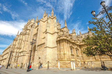 Seville, Andalusia, Spain - April 18, 2016: the side facade of Seville Cathedral a popular landmak.のeditorial素材
