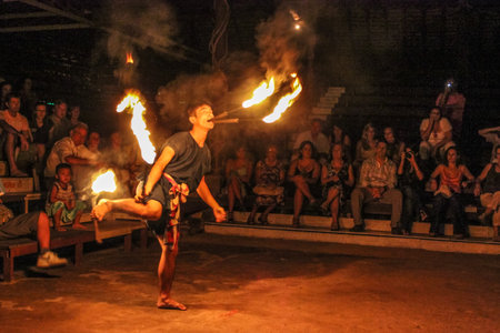 Chiang Mai, Thailand - July 24, 2011: Fire eater performs in a shows at outside the Kantoke Palace in oper air placeのeditorial素材