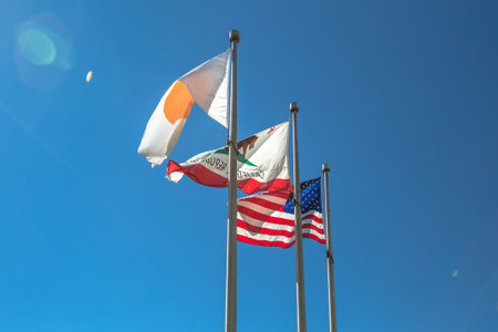 Cupertino, CA, USA - August 15, 2016: close up of flags in front of Apple Headquarters with American Flag and flag with Apple icon.のeditorial素材