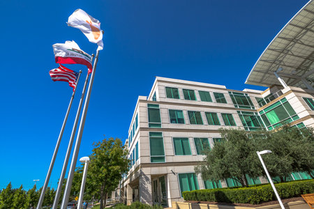 Cupertino, CA, USA - August 15, 2016: flags in front of Apple Headquarters with American Flag and flag with Apple icon. Apple is a multinational corporation that produces technology devise.のeditorial素材
