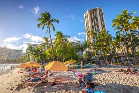 Waikiki, Oahu, Hawaii - August 18, 2016: tourist sunbathing on Waikiki beach at sunset. Waikiki...