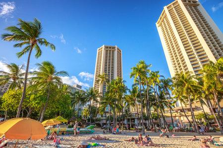 Waikiki, Oahu, Hawaii - August 18, 2016: tourist sunbathing on Waikiki beach at sunset. Waikiki beach, South Shore, is neighborhood of Honolulu and the most popular of Hawai.のeditorial素材
