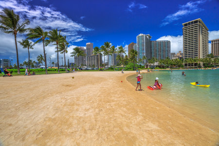 Waikiki, Oahu, Hawaii - August 18, 2016: Hilton Hawaiian Village to the left of Duke Kahanamoku Beach. The beach is one of more popular of Waikiki Beaches because it offers a swimming area protected.のeditorial素材