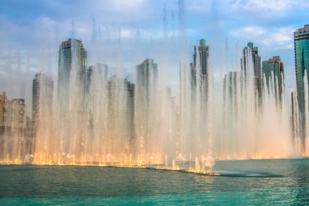The Dubai dancing fountain is the largest of its kind in the world: its water jets, can reach 150 meters high, moving to the rhythm of music and are lit by colored lights and lasers.のeditorial素材