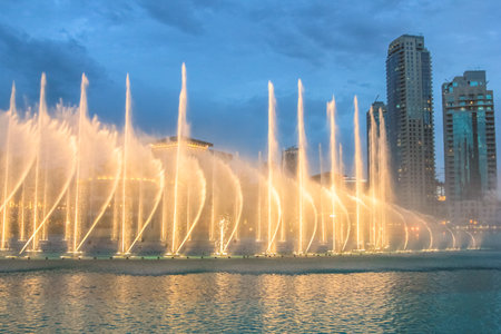Night view of the light show at Dubai Dancing Fountain. The Dubai Fountain, the world largest choreographed fountain on Burj Khalifa Lake area, performs to the beat of the selected music.のeditorial素材