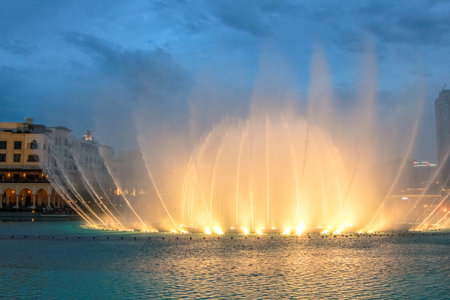 Night view of the light show at Dubai Dancing Fountain. The Dubai Fountain, the world largest choreographed fountain on Burj Khalifa Lake area, performs to the beat of the selected music.のeditorial素材
