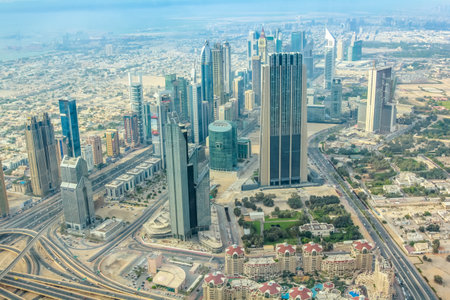 Aerial view of city skyscrapers of Dubai downtown from the top of Burj Khalifa in the United Arab Emirates.のeditorial素材