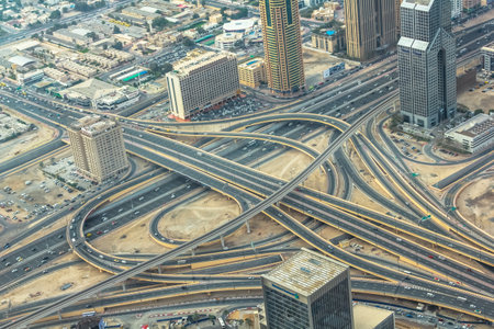 Aerial view of traffic on Sheikh Zayed Road highway interchange in Dubai downtown from top of Burj Khalifa, United Arab Emirates.のeditorial素材