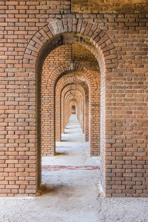 A series of brick arches inside Fort Jefferson. Fort Jefferson is a military historical fortress in the Dry Tortugas National Park, Florida.のeditorial素材