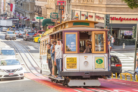 San Francisco, California, United States - August 17, 2016: close up of passengers enjoy a ride in Cable Car Powell-Manson lines, on the Powell Street, Union Square area, in San Francisco downtown.のeditorial素材
