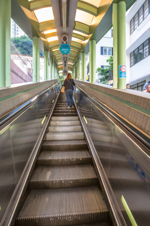 Hong Kong, China - December 4, 2016: People use the Central Mid Levels escalator in Hong Kong, the longest outdoor covered escalator system in the world, to move from Central to Western District.のeditorial素材