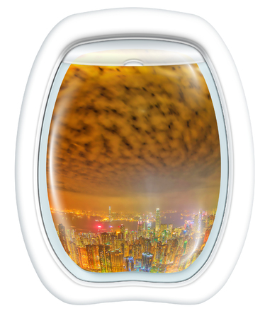 Airplane window on Hong Kong by night, China Asia, from a plane through the porthole window. Concept of transport, travel, vacation and leisure. Fisheye view. Isolated on white background, copy space.の写真素材