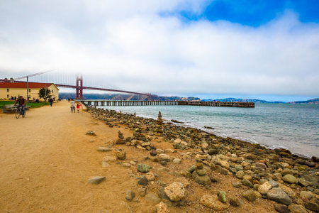 San Francisco, California, United States - August 17, 2016: Golden Gate Bridge with fog from Crissy Field popular beach park for locals and tourists. Leisure and recreational activities concept.のeditorial素材