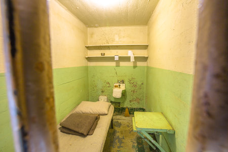 San Francisco, California, United States - August 14, 2016: detail inside Alcatraz ordinary single cell on ground level. All cells have a private toilet, sink and one bed and a small table with chair.のeditorial素材