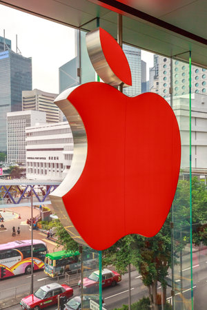 Hong Kong, China - December 4, 2016: close up of Red Apple sign in Apple store, IFC Mall, with Central District skyline on background. Apple is world leader in consumer tablets, computers and mobiles.のeditorial素材