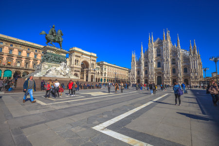 MILAN, ITALY- MARCH 7, 2017: Dome square with Duomo di Milano Cathedral in a blue sky day. Tourists and the equestrian statue of Vittorio Emanuele II and gallery Vittorio Emanuele II.のeditorial素材