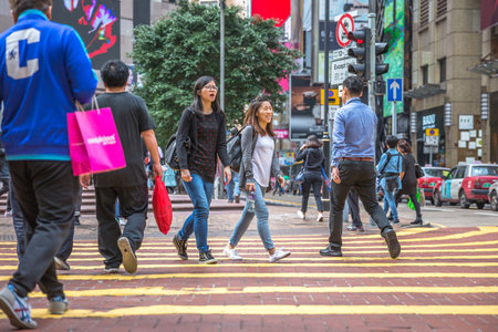 Hong Kong, China - December 6, 2016: two asian friends women talking in Times Square. Causeway Bay is one of the most attractive areas for tourists and business people and good for shopping.のeditorial素材
